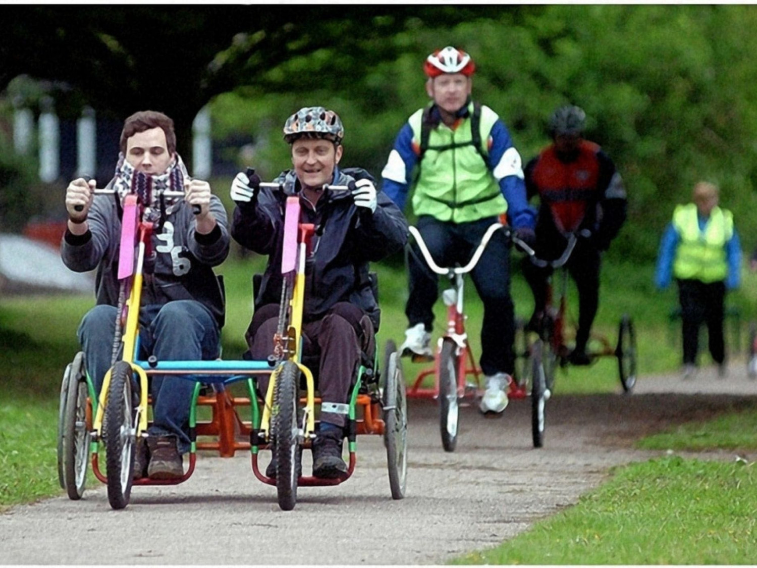 People riding adapted bikes