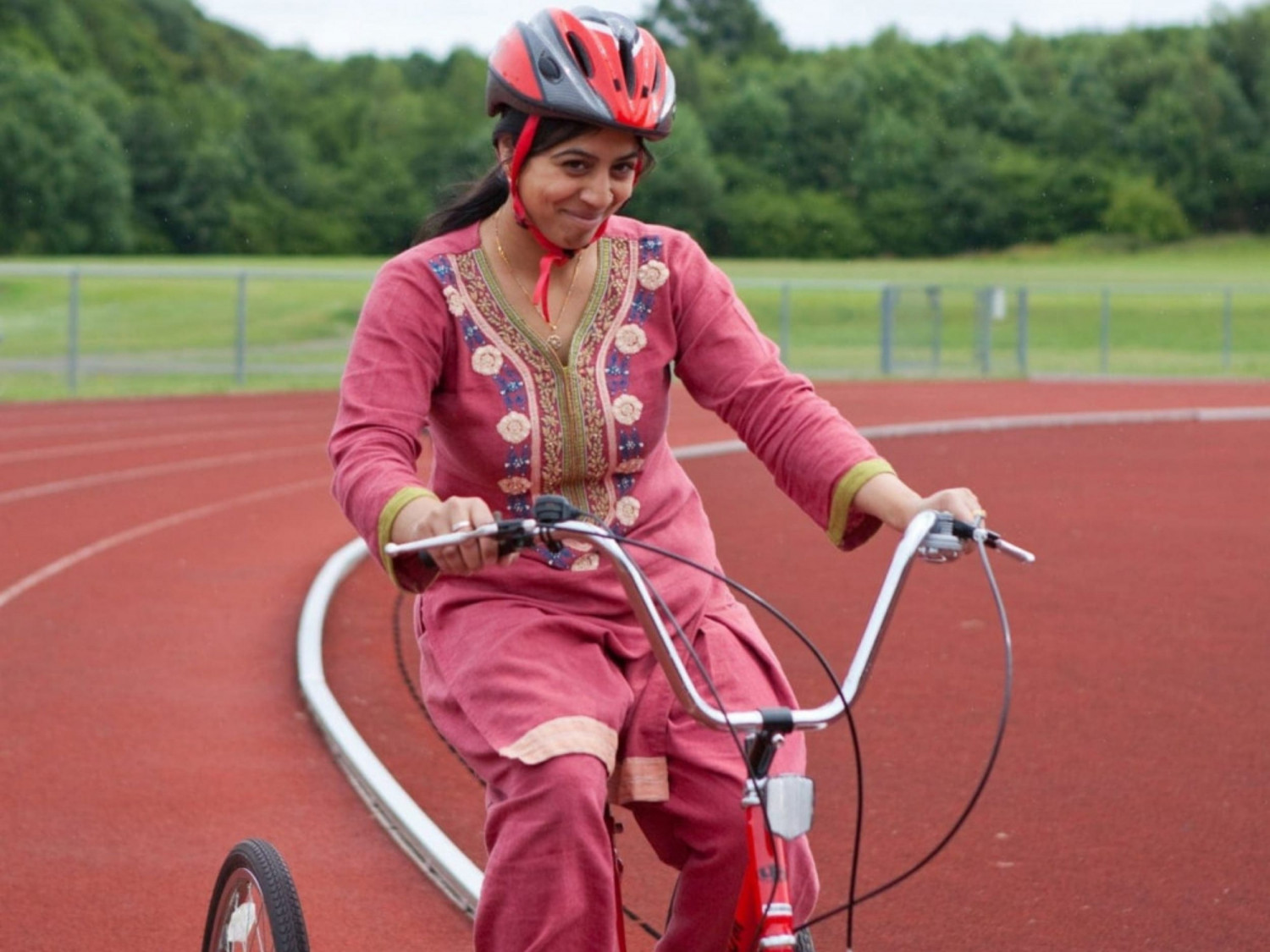 Lady cycling round track
